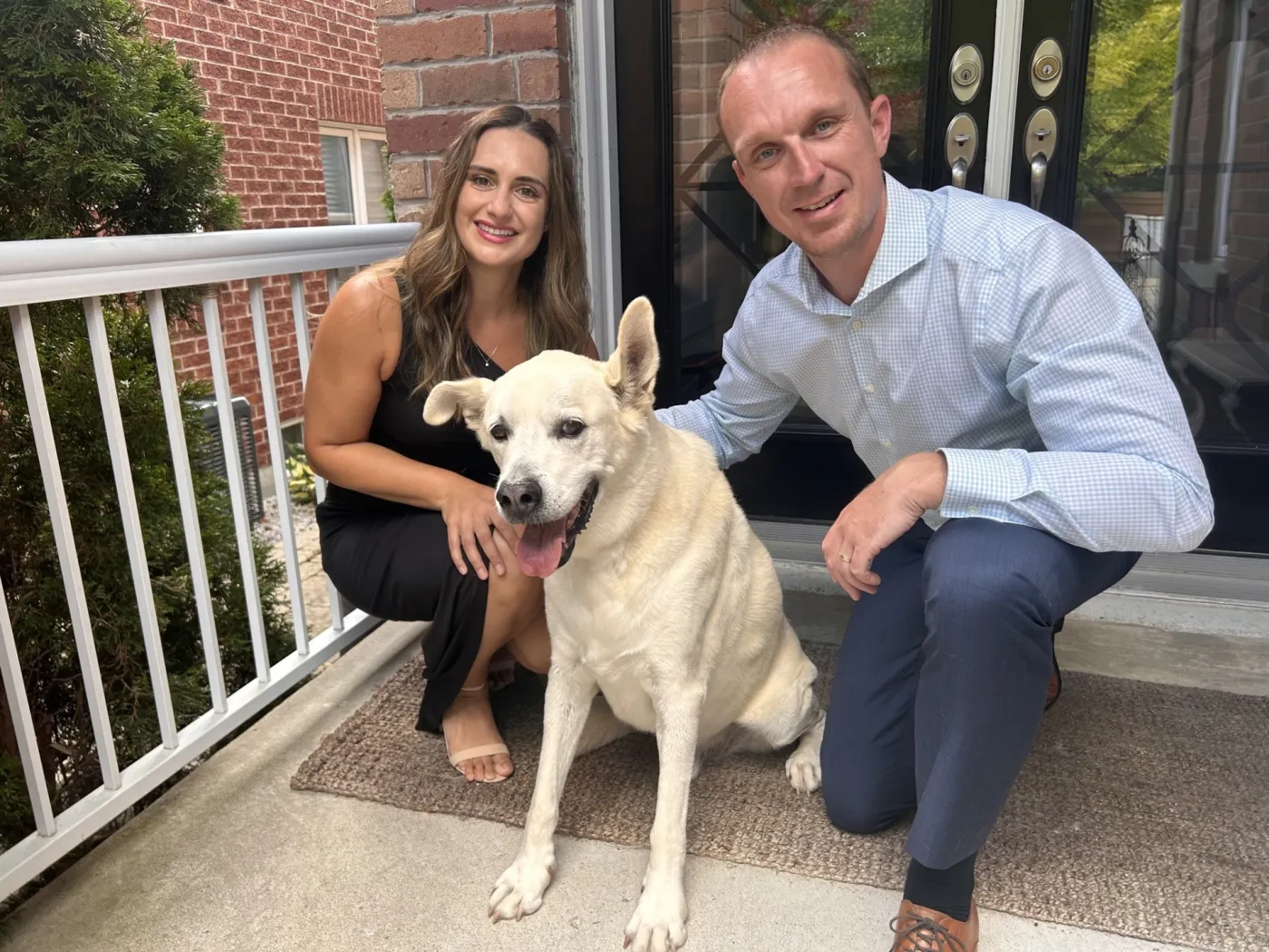 Danny Bell with his partner Amanda and their dog Bailey on the front porch