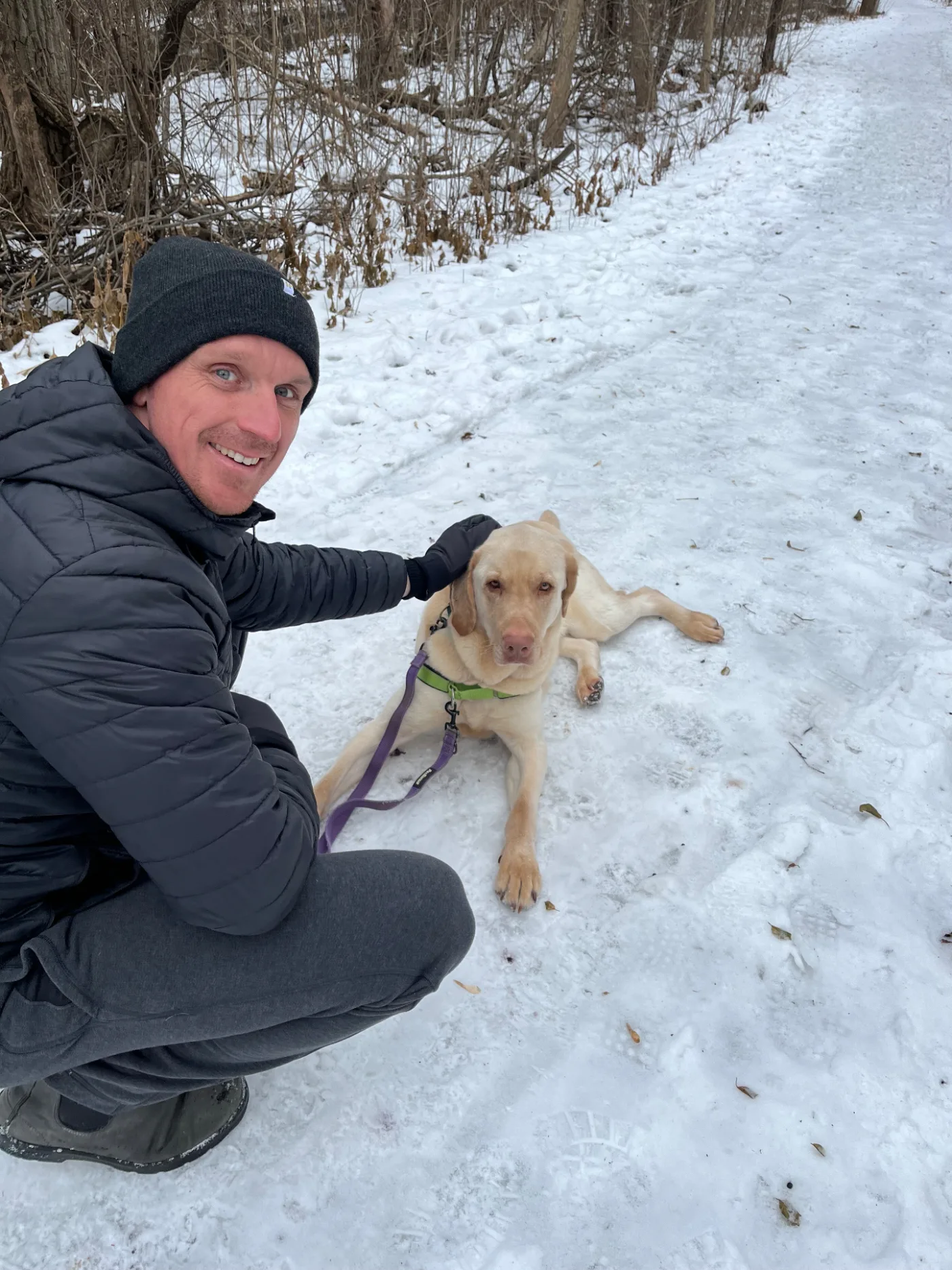 Danny on a winter trail with Rocky, his rescue lab